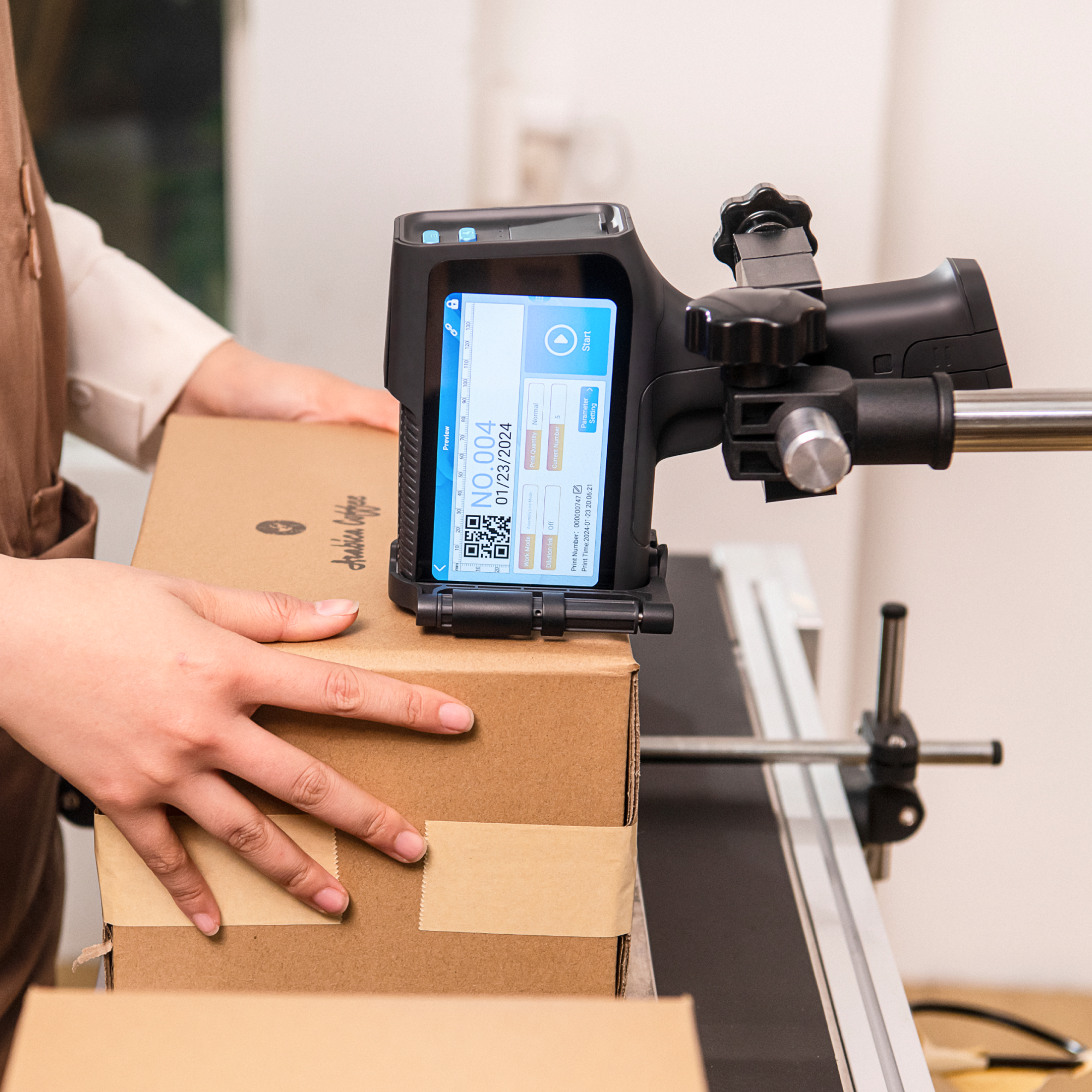 Operator using a conveyor-mounted inkjet printer for carton coding
