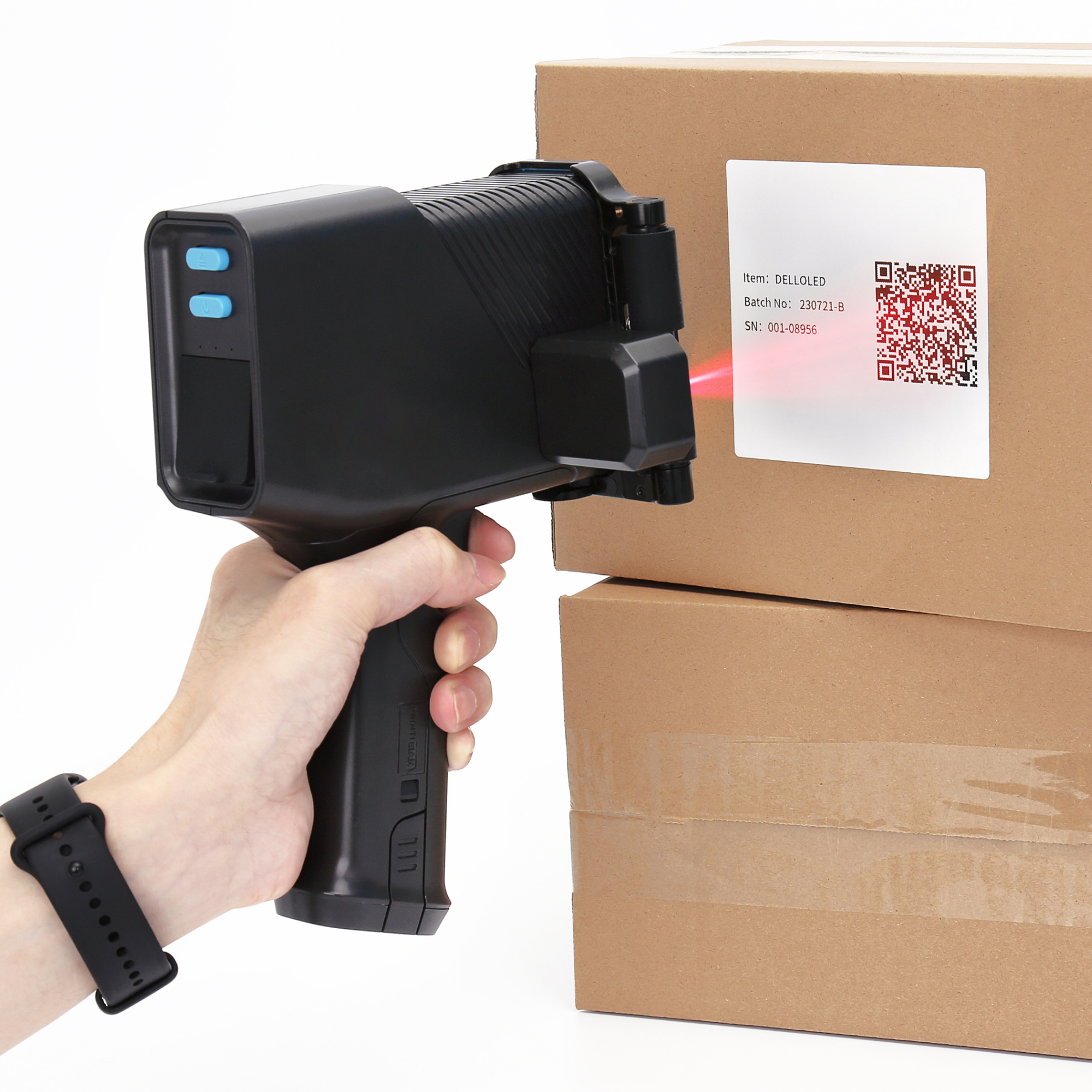 Handheld inkjet printer scanning a QR code label on a carton