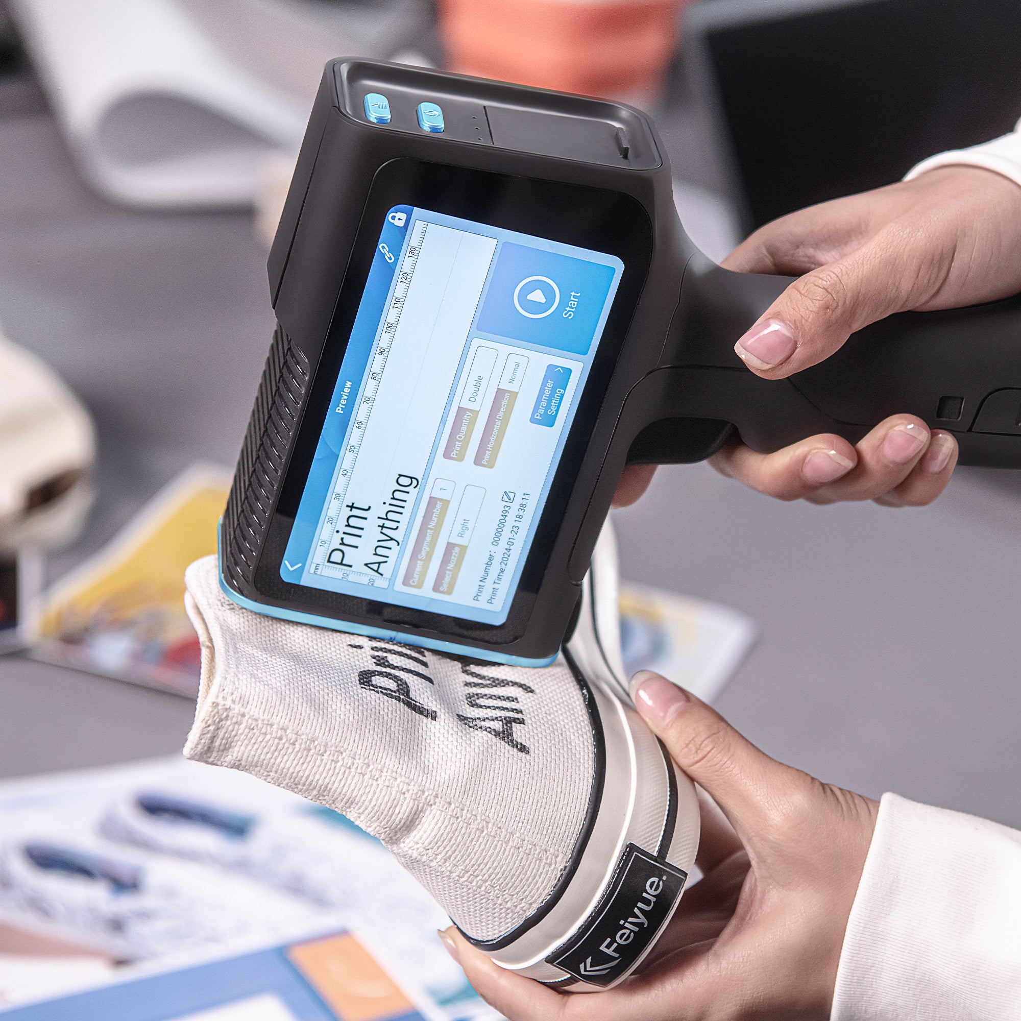 Handheld inkjet printer adding custom text to a fabric shoe