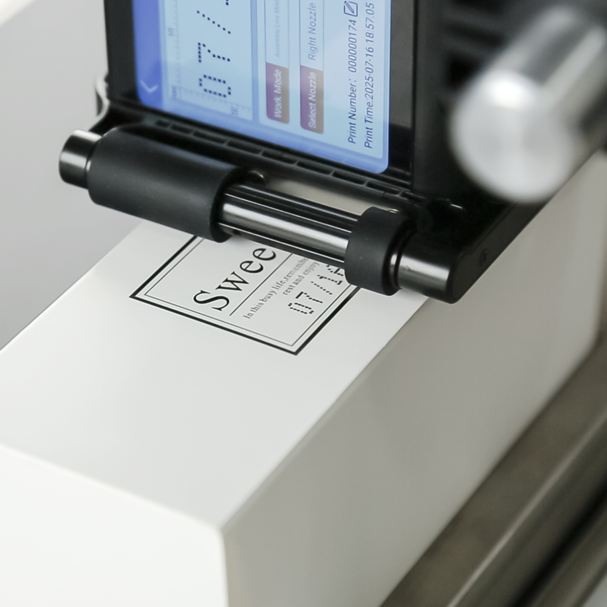 Conveyor inkjet printer marking a product label on a white carton