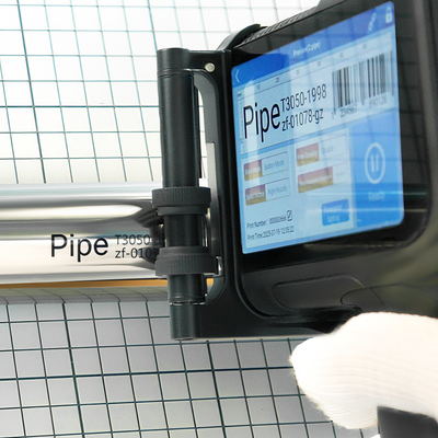 Close-up of a pipe module guiding an inkjet printer along metal pipe