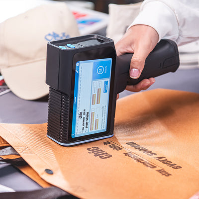Portable inkjet printer marking custom text on an embossed shopping bag