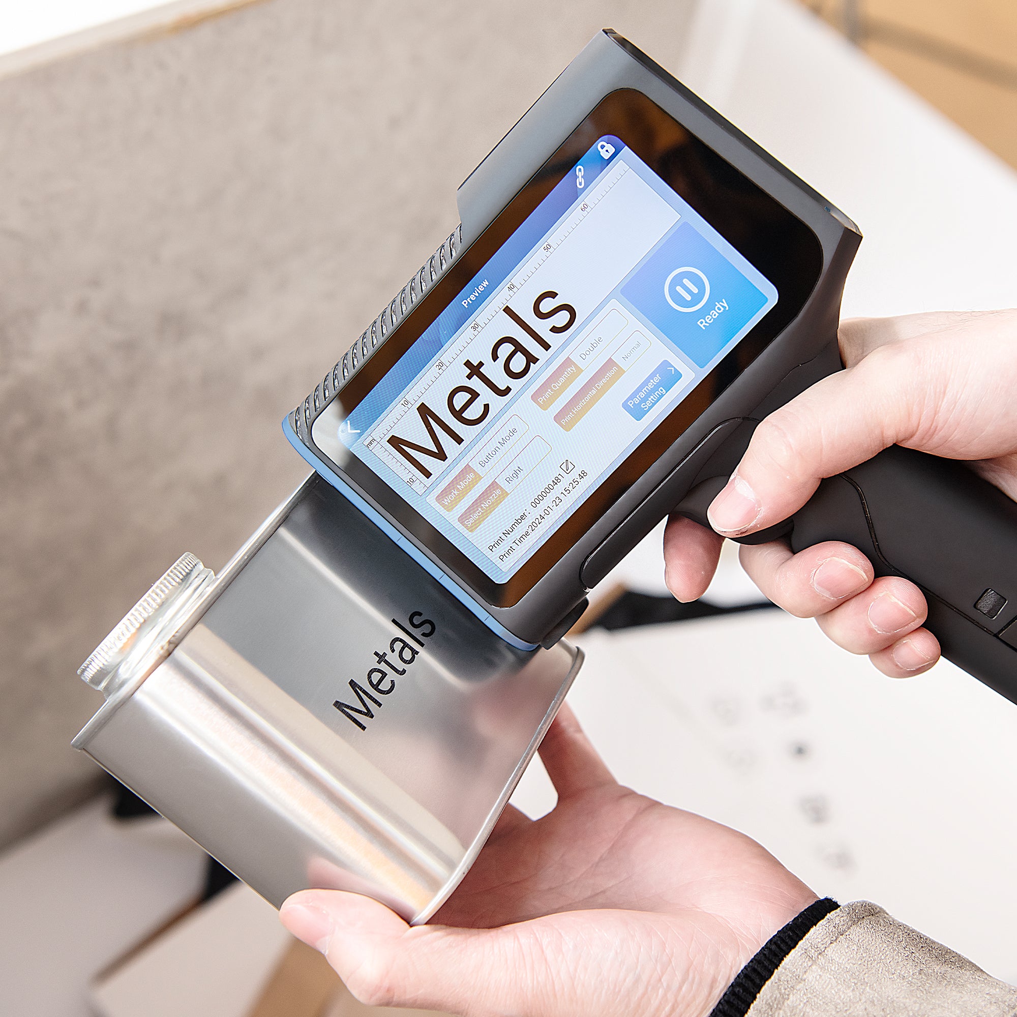Handheld inkjet printer marking permanent text on a metal container